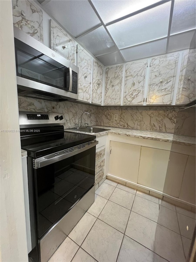 5050 NW 7th St Unit 709, Miami, FL 33126 - kitchen featuring stainless steel appliances and light countertops