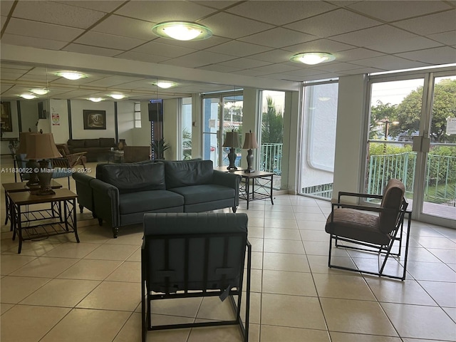 5050 NW 7th St Unit 709, Miami, FL 33126 - living area featuring light tile patterned floors, a drop ceiling, and floor to ceiling windows