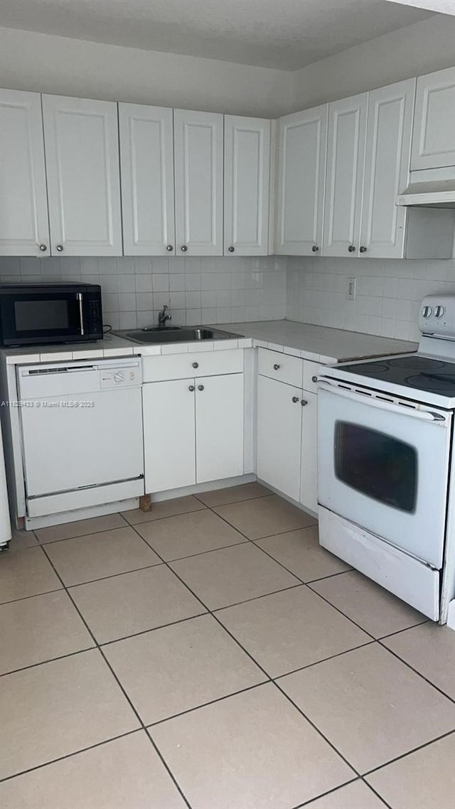 4820 NW 9th Dr Unit 4820, Plantation, FL 33317 - kitchen featuring white appliances, white cabinets, range hood, tasteful backsplash, and tile countertops