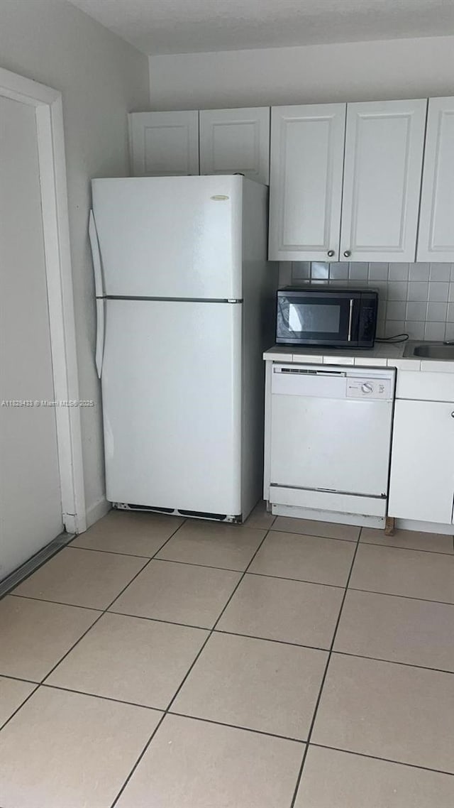 4820 NW 9th Dr Unit 4820, Plantation, FL 33317 - kitchen with white appliances, light tile patterned floors, and white cabinetry