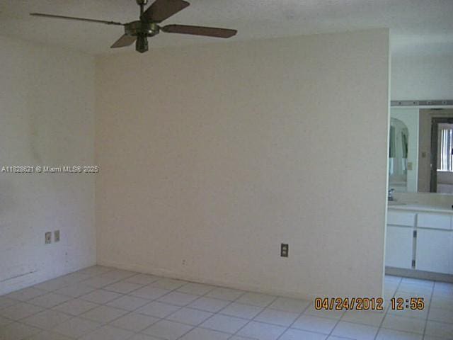 9015 SW 125th Ave Unit N406, Miami, FL 33186 - spare room with a ceiling fan, light tile patterned floors, and arched walkways