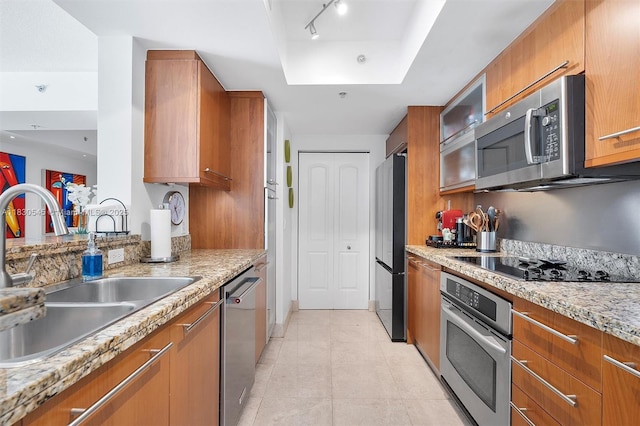 110 Washington Ave Unit 1608, Miami Beach, FL 33139 - kitchen with stainless steel appliances, brown cabinets, and a raised ceiling