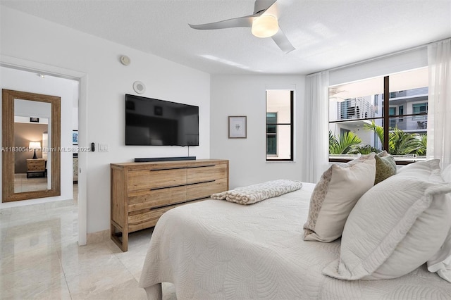 110 Washington Ave Unit 1608, Miami Beach, FL 33139 - bedroom featuring a ceiling fan and a textured ceiling