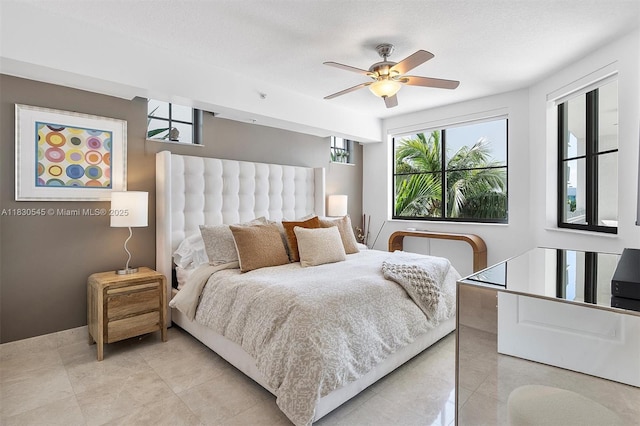 110 Washington Ave Unit 1608, Miami Beach, FL 33139 - bedroom with multiple windows, light tile patterned floors, and a ceiling fan