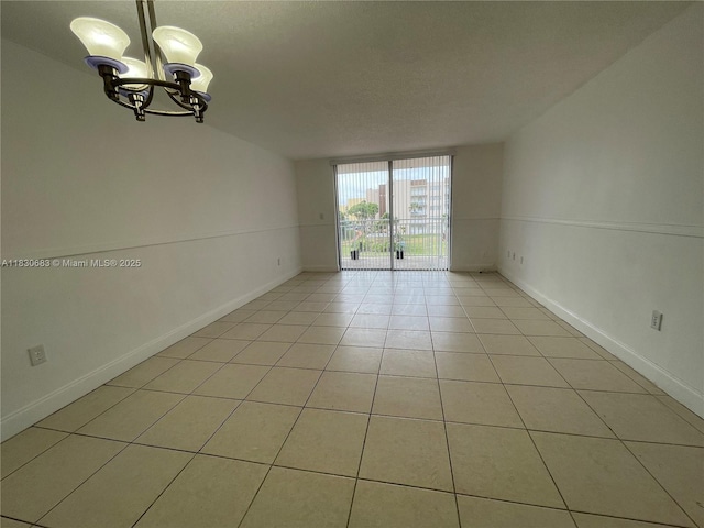6940 Miami Gardens Dr Unit 1-329, Hialeah, FL 33015 - spare room featuring a chandelier, light tile patterned floors, and a textured ceiling