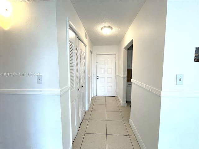 6940 Miami Gardens Dr Unit 1-329, Hialeah, FL 33015 - corridor featuring light tile patterned floors and a textured ceiling