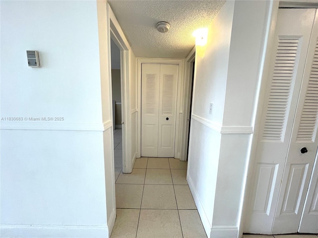 6940 Miami Gardens Dr Unit 1-329, Hialeah, FL 33015 - hall featuring light tile patterned floors and a textured ceiling