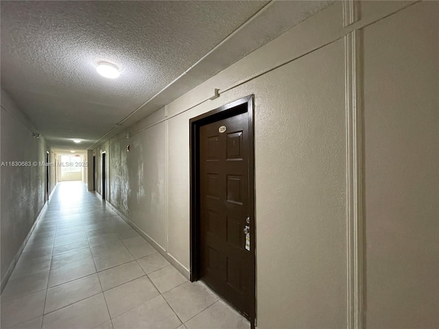 6940 Miami Gardens Dr Unit 1-329, Hialeah, FL 33015 - hall with a textured ceiling, light tile patterned floors, and a textured wall