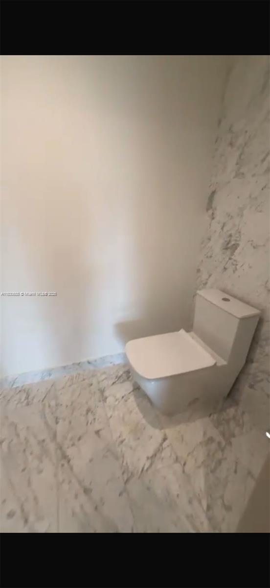 1000 Brickell Plz Unit 2008, Miami, FL 33131 - bathroom with toilet and marble finish flooring