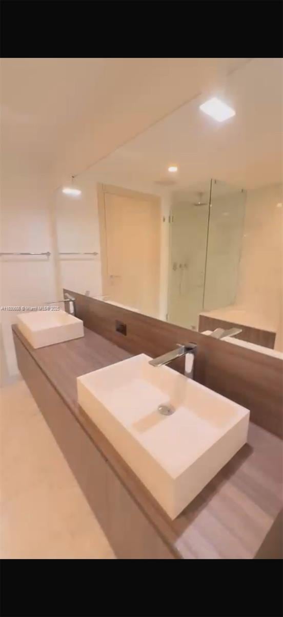 1000 Brickell Plz Unit 2008, Miami, FL 33131 - full bathroom featuring double vanity and a stall shower