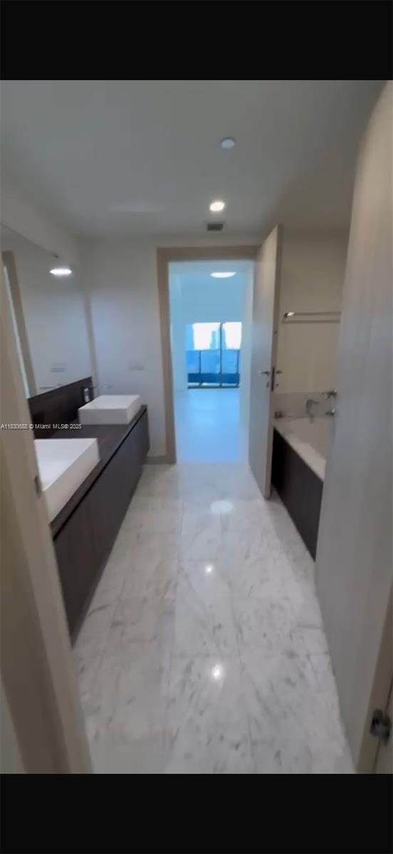1000 Brickell Plz Unit 2008, Miami, FL 33131 - full bath with vanity, a tub to relax in, and marble finish flooring