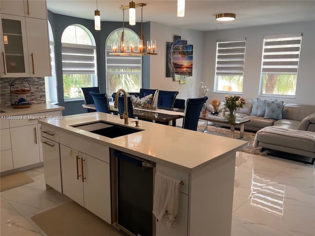 3916 Passion Flower Rd, Coconut Creek, FL 33073 - kitchen featuring light marble finish flooring, open floor plan, light countertops, and white cabinets