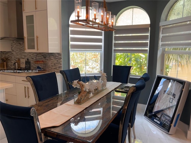 3916 Passion Flower Rd, Coconut Creek, FL 33073 - dining area featuring a chandelier, plenty of natural light, and light marble finish flooring