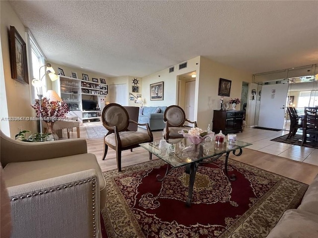 1200 Saint Charles Pl Unit 708, Pembroke Pines, FL 33026 - living area with a textured ceiling and wood finished floors