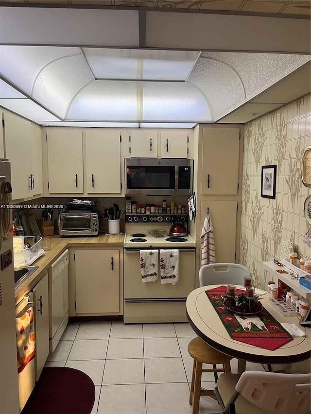 1200 Saint Charles Pl Unit 708, Pembroke Pines, FL 33026 - kitchen with white appliances, light countertops, and light tile patterned floors