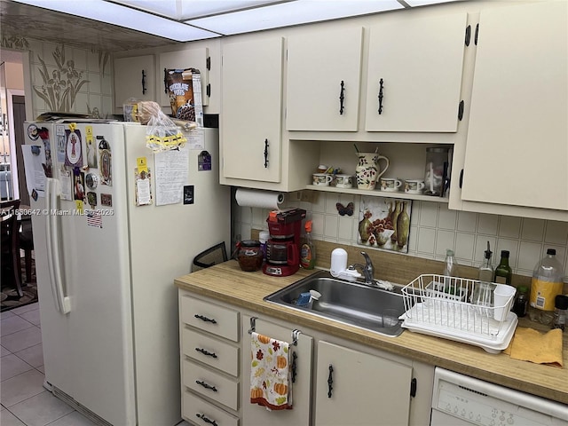 1200 Saint Charles Pl Unit 708, Pembroke Pines, FL 33026 - kitchen with white appliances, backsplash, light tile patterned floors, light countertops, and white cabinetry
