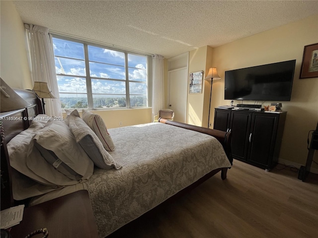 1200 Saint Charles Pl Unit 708, Pembroke Pines, FL 33026 - bedroom featuring wood finished floors and a textured ceiling