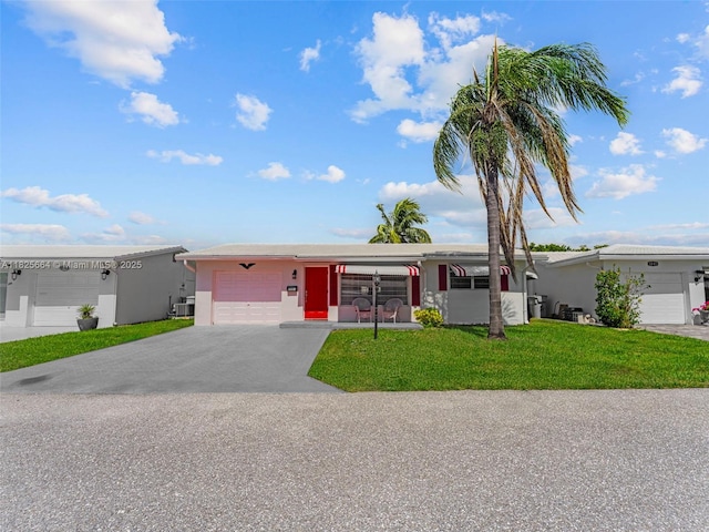 2991 NW 1st Dr, Pompano Beach, FL 33064 - view of front facade featuring a garage, a front yard, driveway, and stucco siding