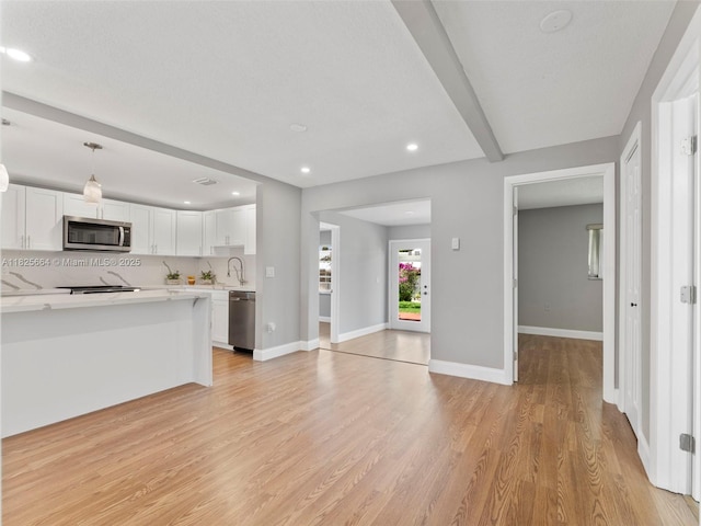 2991 NW 1st Dr, Pompano Beach, FL 33064 - unfurnished living room featuring light wood finished floors and recessed lighting