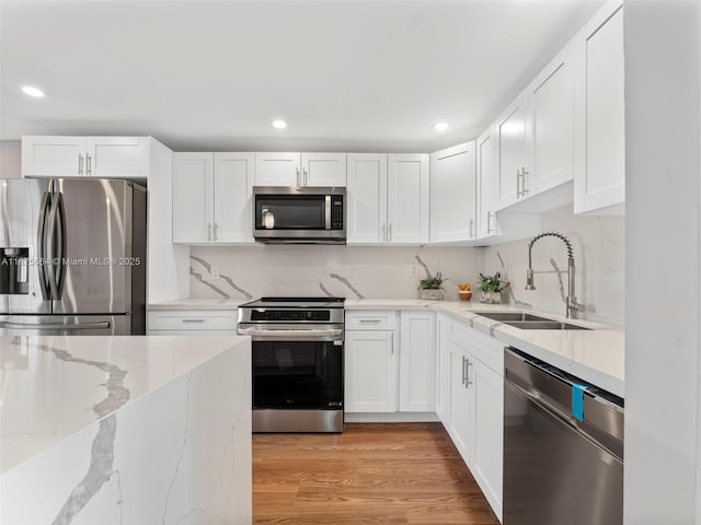 2991 NW 1st Dr, Pompano Beach, FL 33064 - kitchen featuring stainless steel appliances, white cabinetry, and recessed lighting