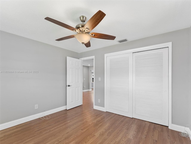 2991 NW 1st Dr, Pompano Beach, FL 33064 - unfurnished bedroom featuring wood finished floors, a closet, and a ceiling fan