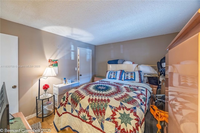 3531 Inverrary Dr Unit 101, Lauderhill, FL 33319 - bedroom with light wood-type flooring and a textured ceiling