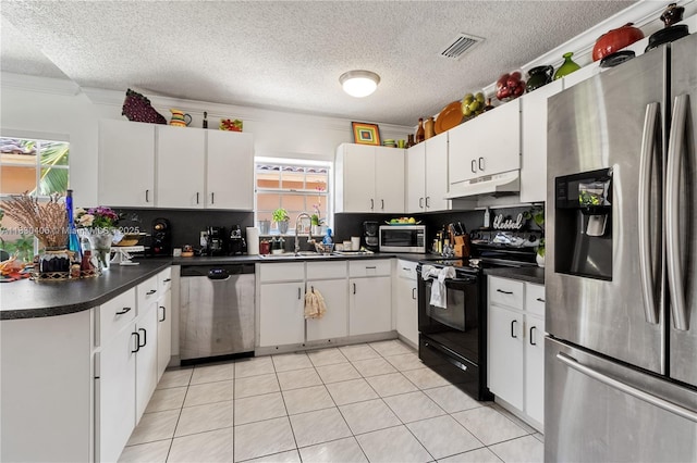 5443 SW 143rd Ct, Miami, FL 33175 - kitchen featuring stainless steel appliances, under cabinet range hood, dark countertops, a textured ceiling, and white cabinets
