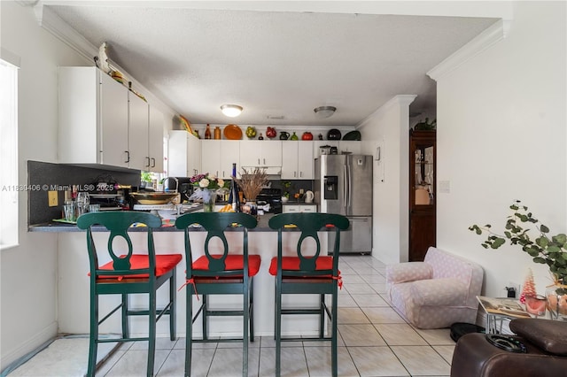 5443 SW 143rd Ct, Miami, FL 33175 - kitchen featuring stainless steel fridge with ice dispenser, crown molding, a peninsula, dark countertops, and white cabinets