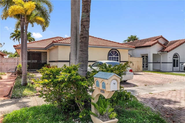 5443 SW 143rd Ct, Miami, FL 33175 - mediterranean / spanish house with stucco siding, a tiled roof, and a gate