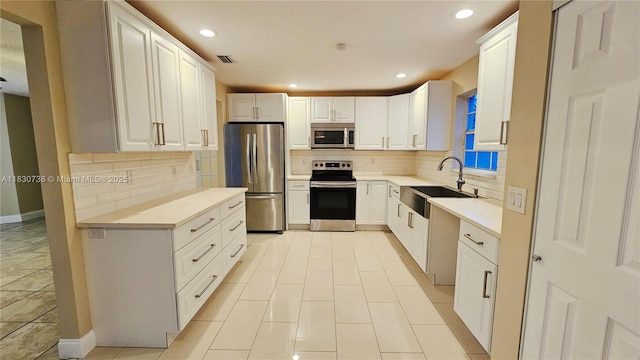 1336 NW 129th Way, Sunrise, FL 33323 - kitchen with appliances with stainless steel finishes, decorative backsplash, recessed lighting, light countertops, and white cabinets