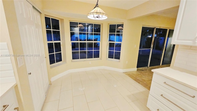 1336 NW 129th Way, Sunrise, FL 33323 - unfurnished dining area featuring tile patterned flooring and baseboards