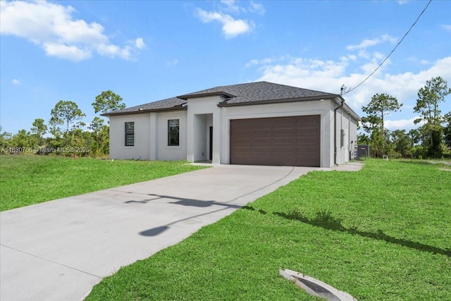 1212 Edelweiss St E, Lehigh Acres, FL 33974 - prairie-style home featuring stucco siding, concrete driveway, an attached garage, a front yard, and a shingled roof