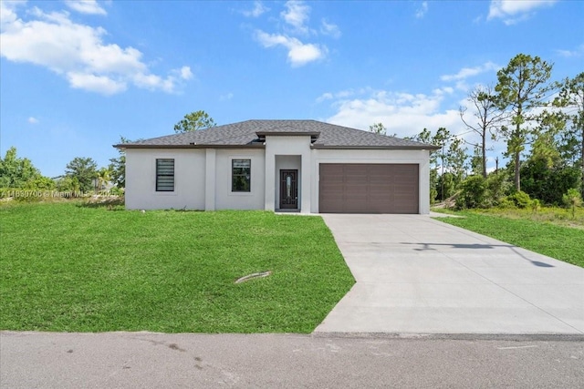 1212 Edelweiss St E, Lehigh Acres, FL 33974 - prairie-style home with stucco siding, a garage, driveway, a front lawn, and roof with shingles