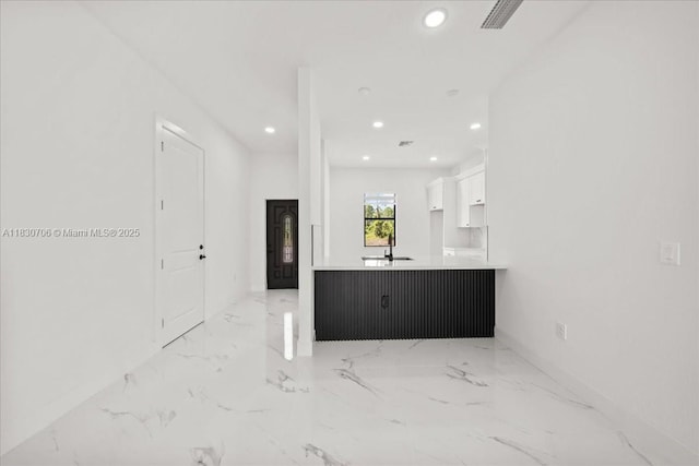 1212 Edelweiss St E, Lehigh Acres, FL 33974 - unfurnished living room with recessed lighting and light marble finish flooring