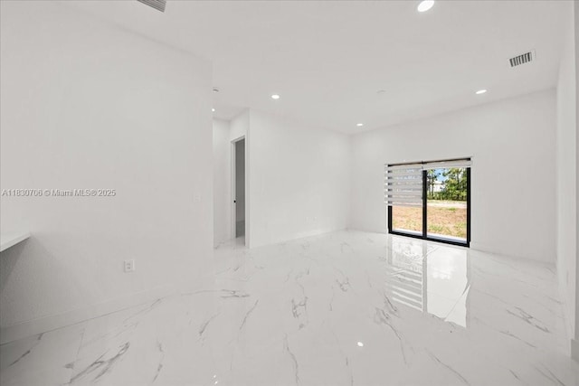 1212 Edelweiss St E, Lehigh Acres, FL 33974 - unfurnished room with marble tiled floors and recessed lighting