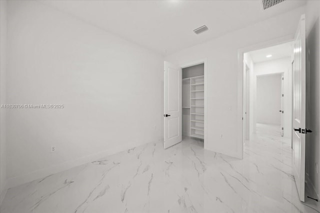 1212 Edelweiss St E, Lehigh Acres, FL 33974 - unfurnished bedroom with marble finish floors, a spacious closet, and a closet