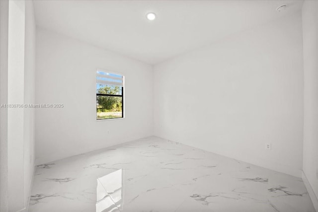 1212 Edelweiss St E, Lehigh Acres, FL 33974 - empty room featuring marble tiled flooring and recessed lighting