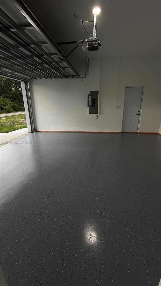 1212 Edelweiss St E, Lehigh Acres, FL 33974 - garage with a garage door opener and electric panel