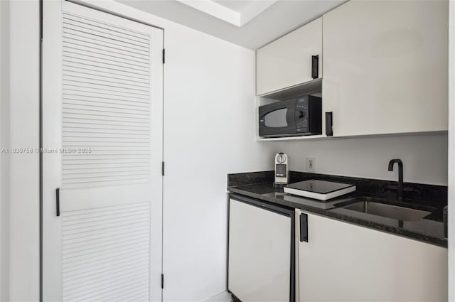 791 Crandon Blvd Unit C.854, Key Biscayne, FL 33149 - kitchen with black microwave, white cabinetry, and dark stone countertops