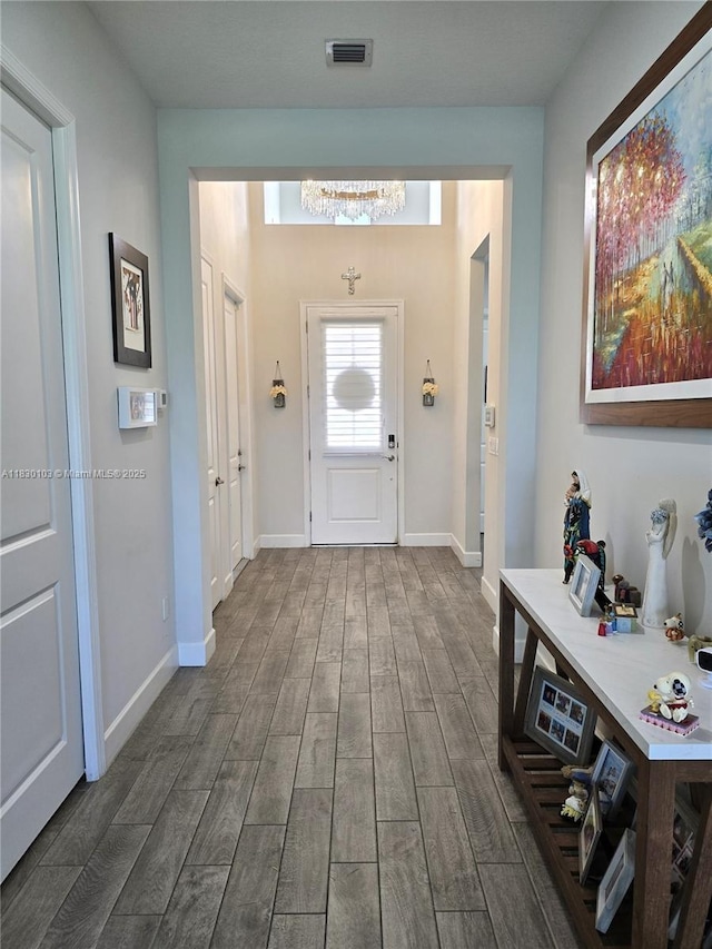 16190 Melogold Dr, Loxahatchee, FL 33470 - entryway featuring dark wood-style flooring and a chandelier