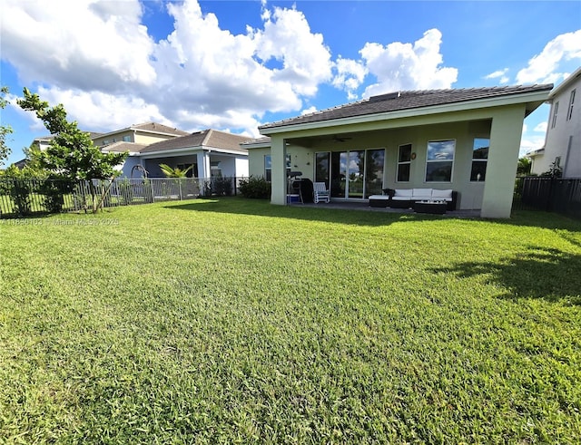16190 Melogold Dr, Loxahatchee, FL 33470 - rear view of property featuring stucco siding, a fenced backyard, a ceiling fan, and a patio area