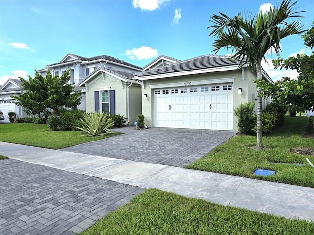 16190 Melogold Dr, Loxahatchee, FL 33470 - single story home with an attached garage, stucco siding, decorative driveway, a front lawn, and a tile roof