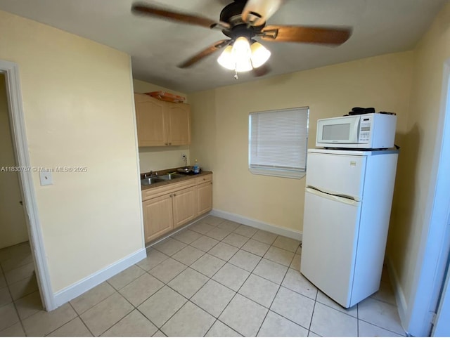 6433 SW 22nd St, Miramar, FL 33023 - kitchen with refrigerator, white microwave, ceiling fan, and light tile patterned floors