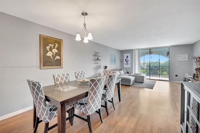 3650 Environ Blvd Unit 502, Lauderhill, FL 33319 - dining space featuring light wood-type flooring and a chandelier