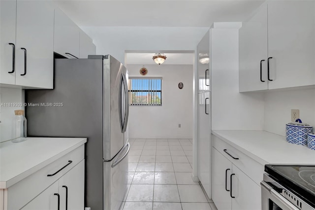 3650 Environ Blvd Unit 502, Lauderhill, FL 33319 - kitchen featuring appliances with stainless steel finishes, light countertops, white cabinetry, and light tile patterned floors