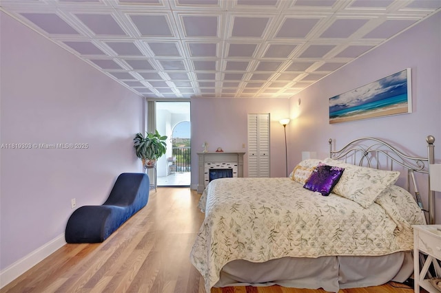 3650 Environ Blvd Unit 502, Lauderhill, FL 33319 - bedroom featuring wood finished floors, access to outside, an ornate ceiling, a fireplace, and a closet