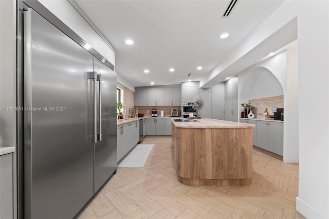 15202 SW 80th Ave, Palmetto Bay, FL 33157 - kitchen featuring appliances with stainless steel finishes, gray cabinets, light countertops, a kitchen island, and recessed lighting