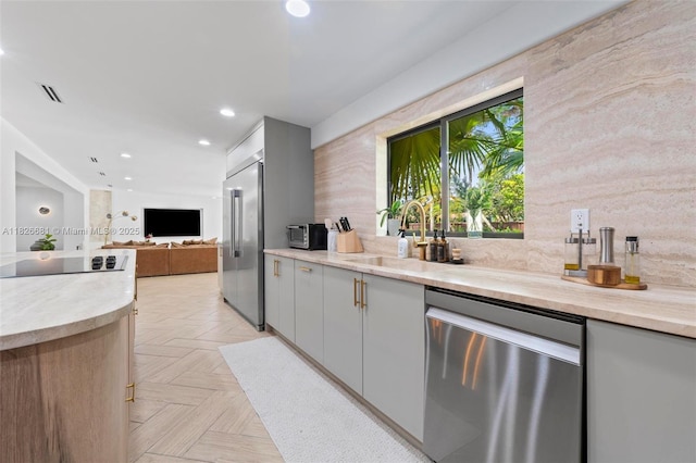 15202 SW 80th Ave, Palmetto Bay, FL 33157 - kitchen with stainless steel appliances, open floor plan, light countertops, recessed lighting, and gray cabinetry