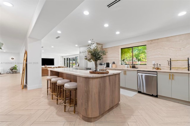 15202 SW 80th Ave, Palmetto Bay, FL 33157 - kitchen featuring dishwasher, a kitchen island, light countertops, recessed lighting, and a breakfast bar area