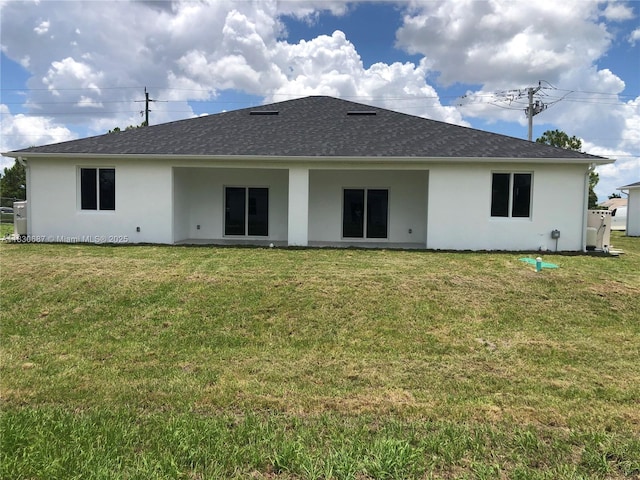4568/4570 Golfview Blvd, Lehigh Acres, FL 33973 - rear view of house with a lawn, stucco siding, and roof with shingles